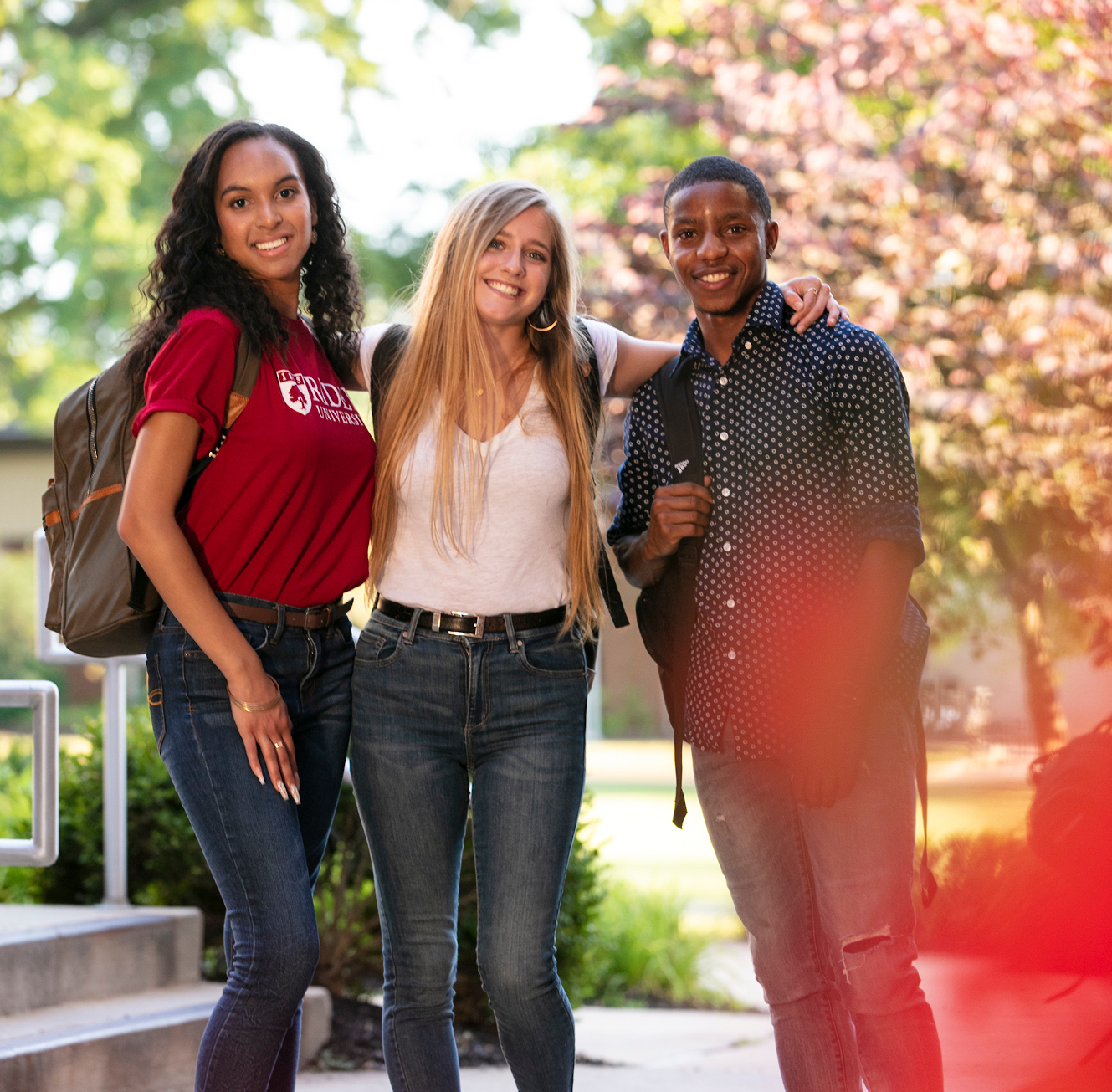 Three students pose for photo on Rider campus.