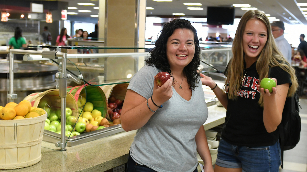 Two students pose in Daly Dining Hall