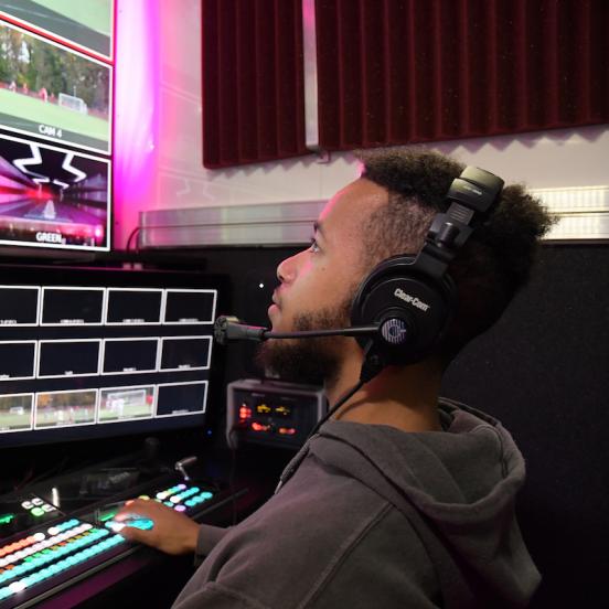 Student in front of a variety of screens as a producer