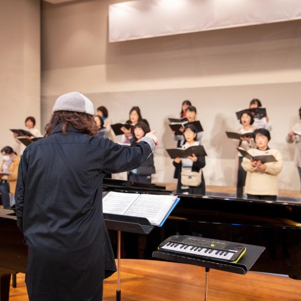 Conductor directs women's chorus