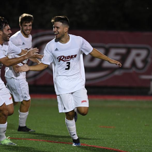 Men's soccer players celebrate