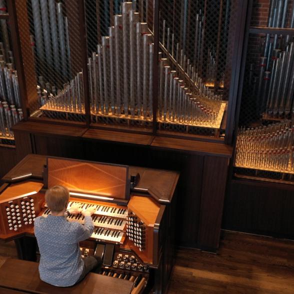 Student playing organ