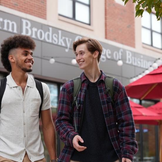 Rider students walk and talk outside the Norm Brodsky College of Business