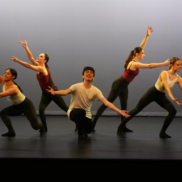 a male dancer in front and four female dancers behind him.