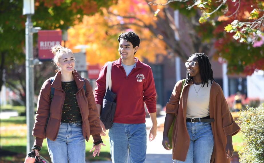 Students walking campus in the fall