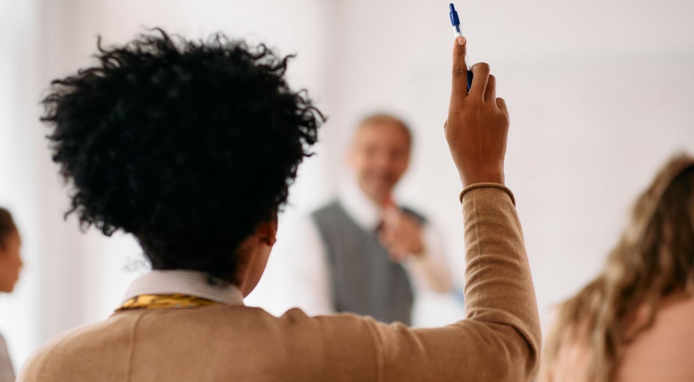 Student raising arm in classroom