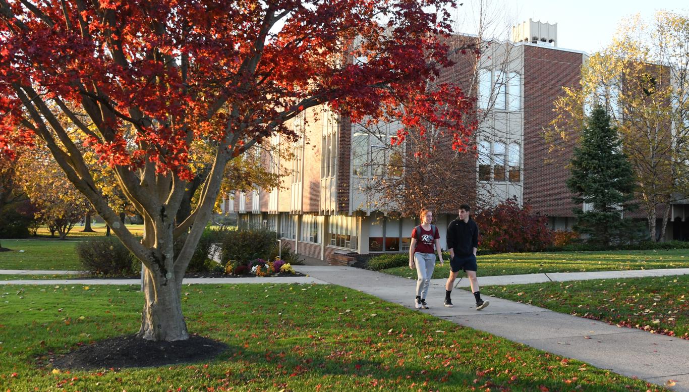 Two students walk in front of Moore Library