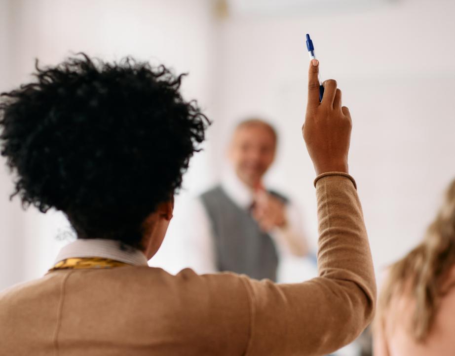 Student raising arm in classroom