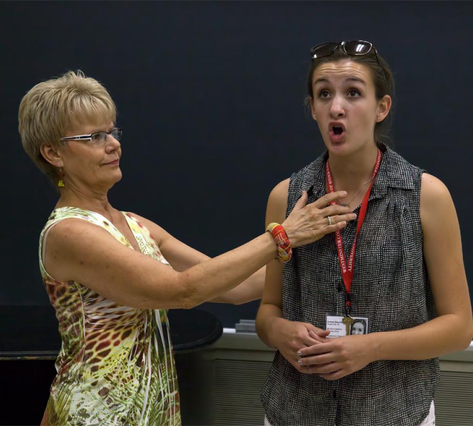 Faculty member teaches voice student.
