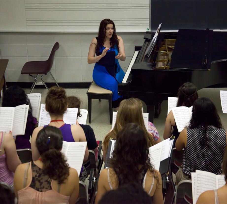 Faculty member teaches vocal institute students.